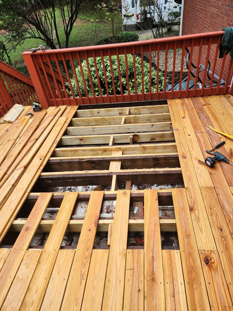 Deck with old boards removed and new boards going down over the joists