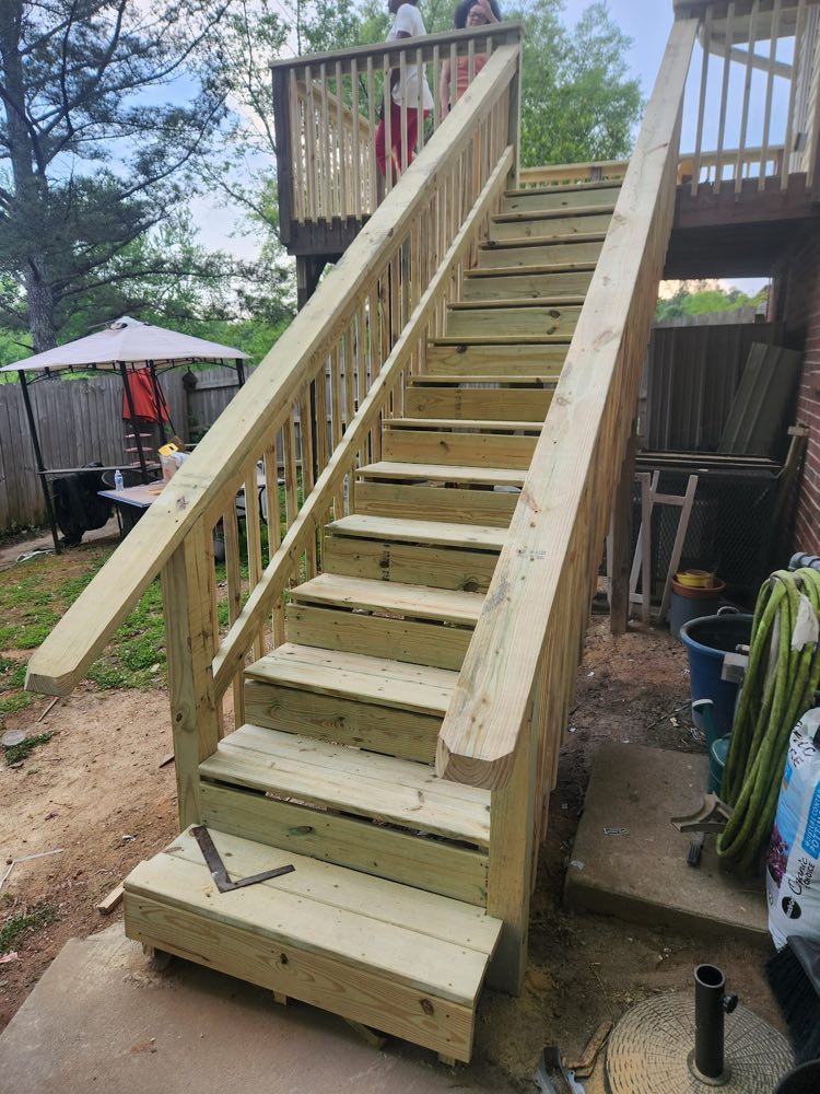 New wooden staircase with railings leading up to a deck